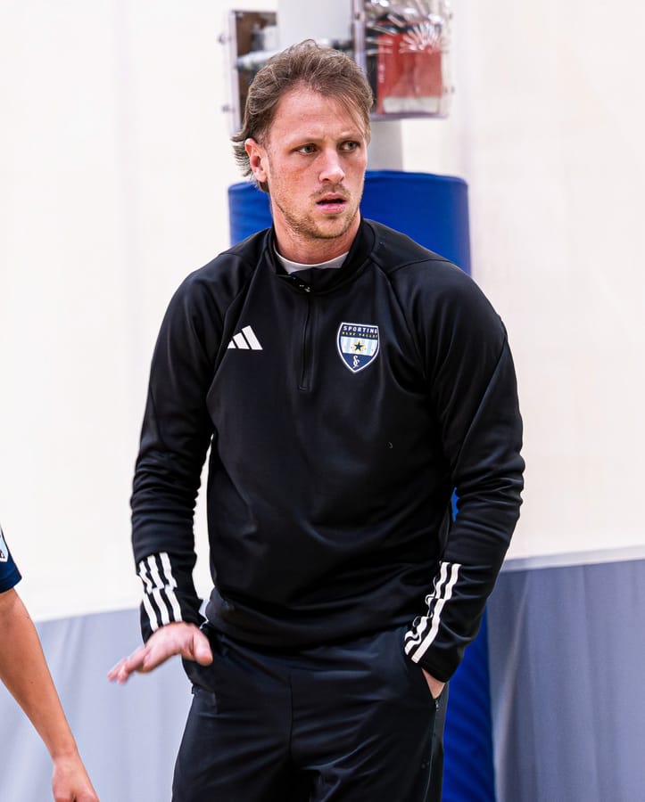 An SBV coach watching play from the side of the court